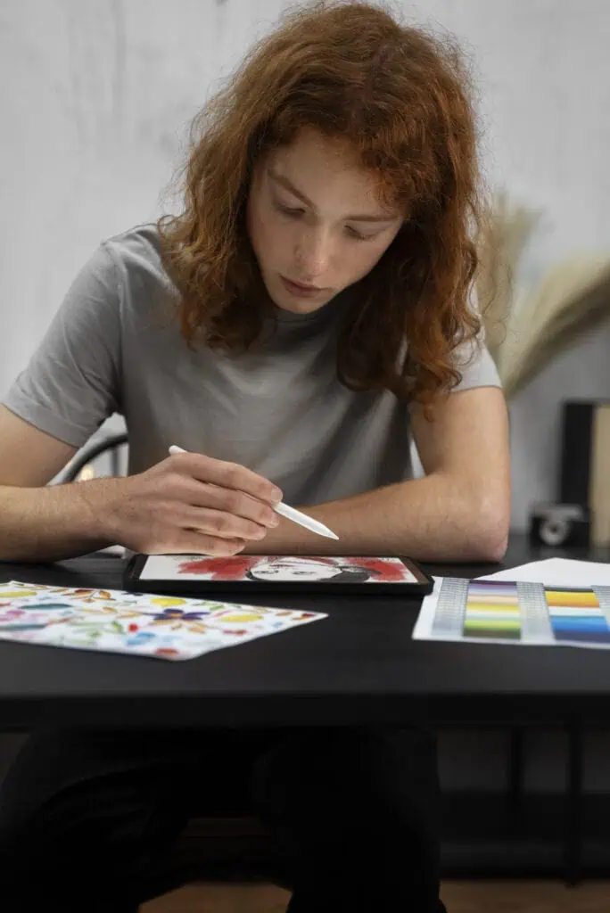 Woman drawing designs on iPad in office
