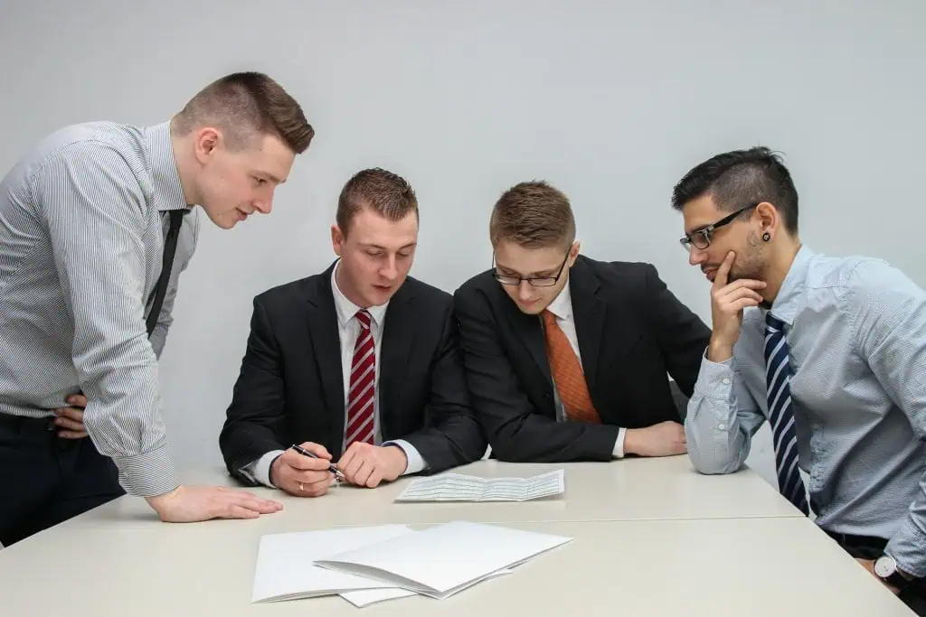Four program managers gathered around table to discuss matters